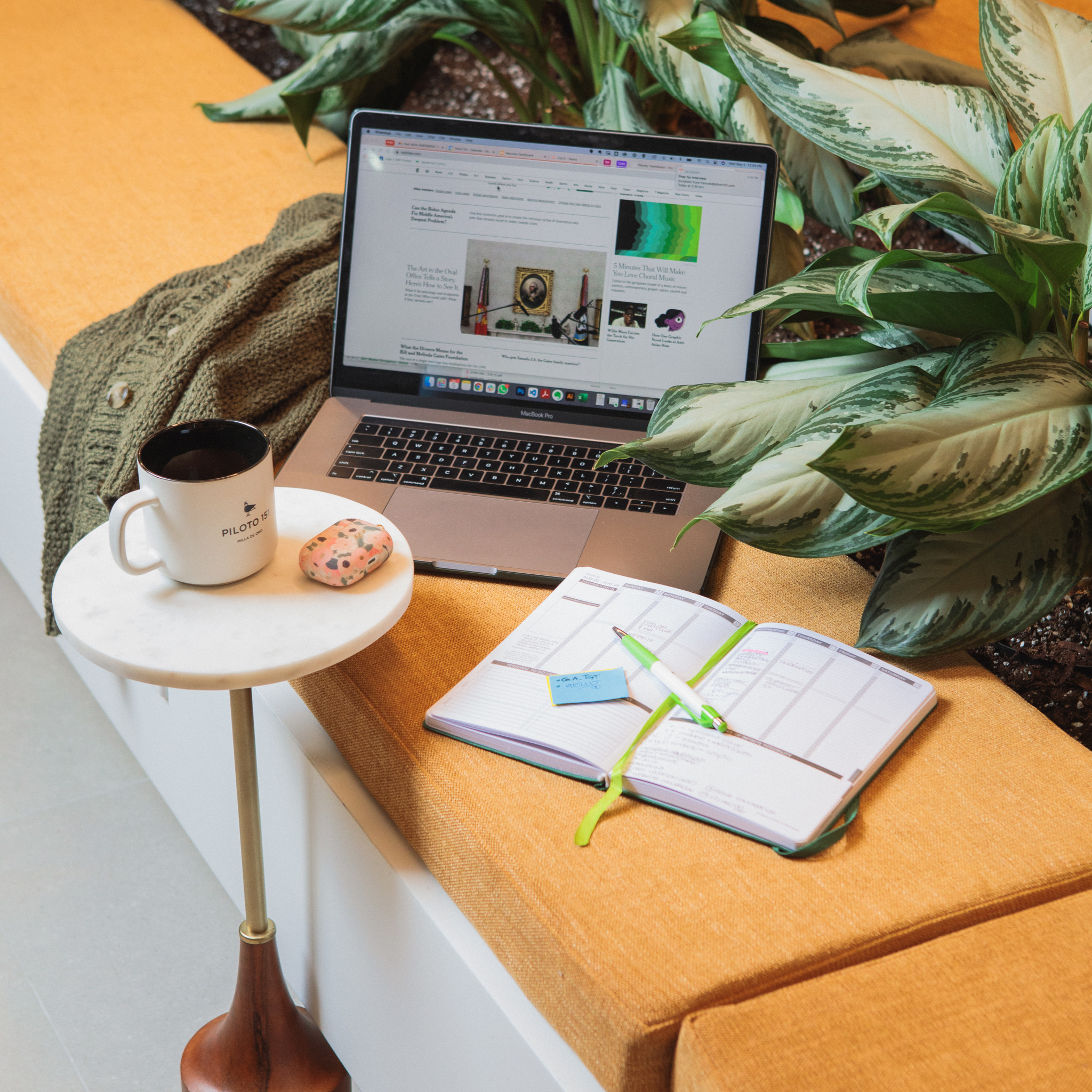 A computer, coffee mug and agenda